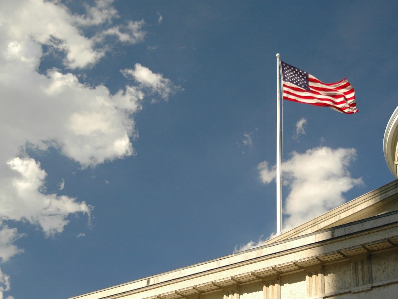 Exterior of a city building with an American flag on it.