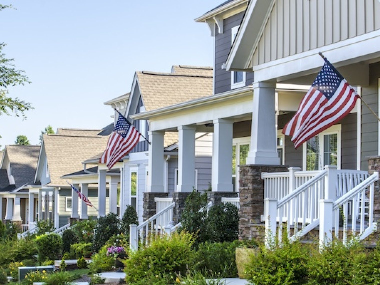 Street of houses displaying American flags.