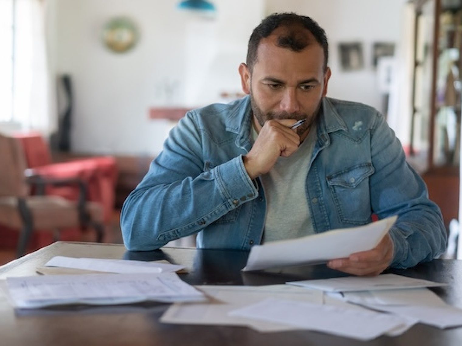 Man checking his finances and looking worried.