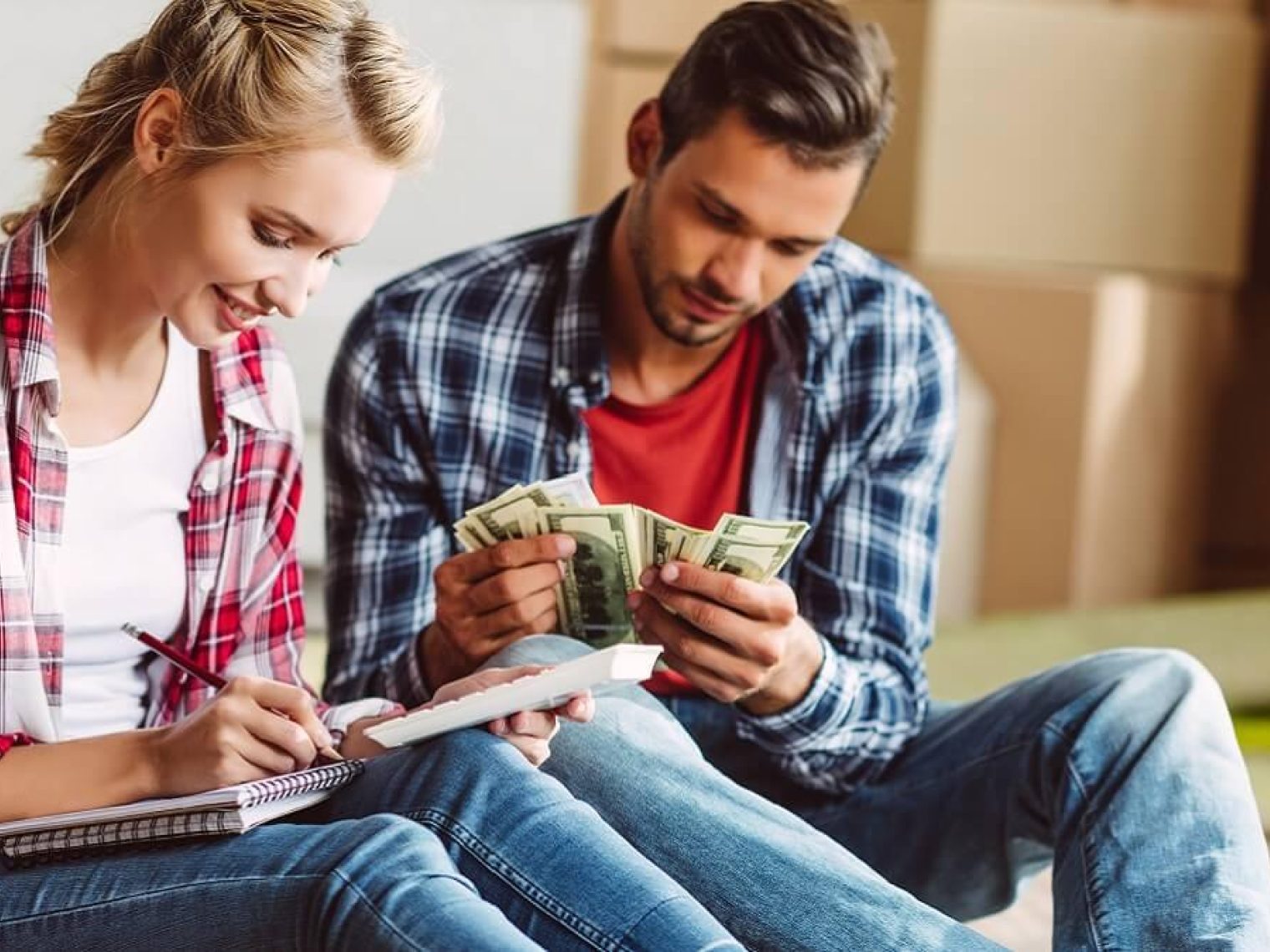 Young couple counting money together.