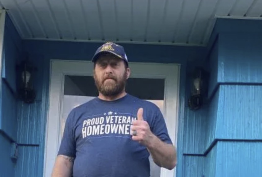 picture of Ryan M. in front of a house