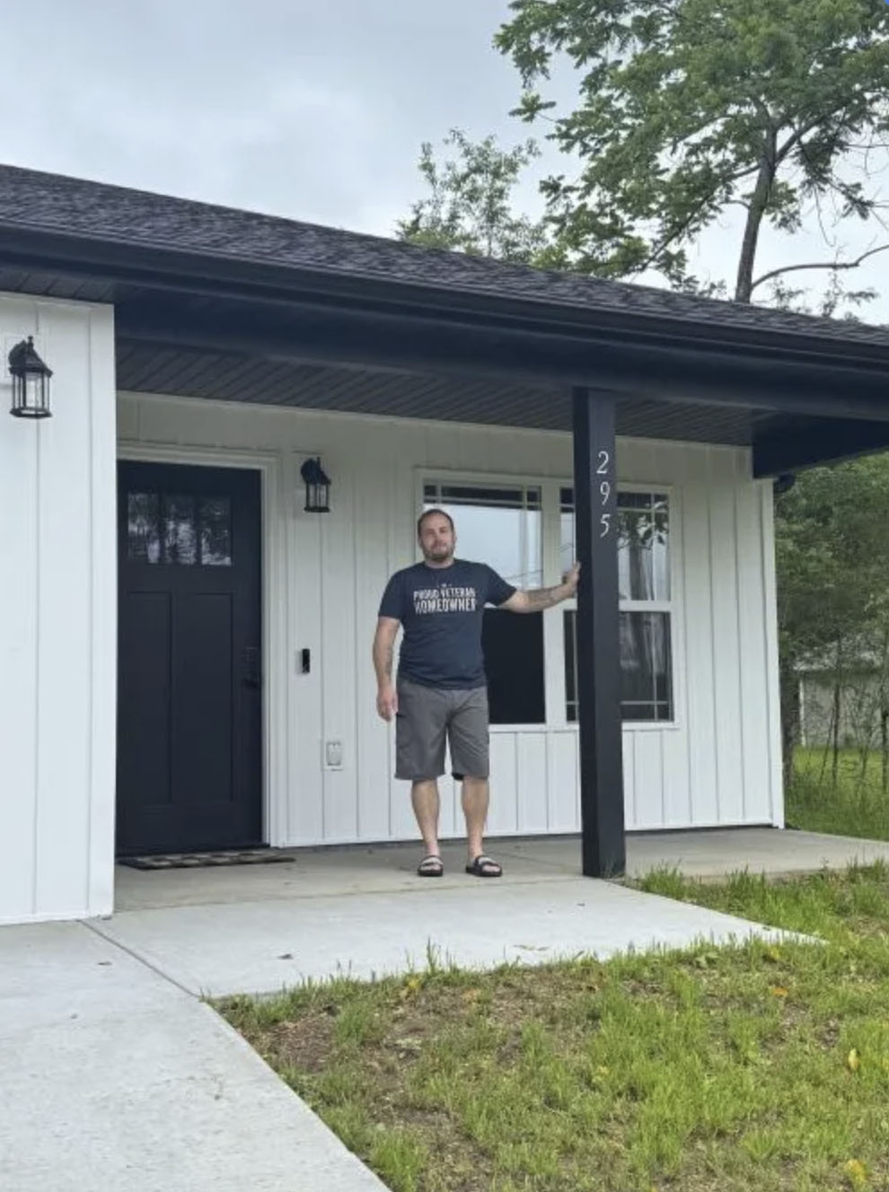 picture of Dennis R. in front of a house